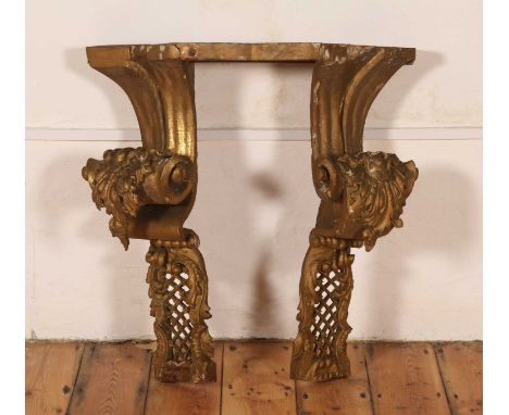 A carved giltwood and gesso console table, probably 18th century Italian, having elaborately scrolled legs, h.81cm, w.76cm