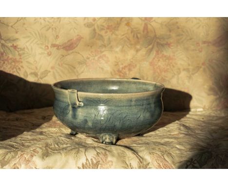 A Chinese blue glazed porcelain censer, having carved decoration and standing upon a tripod base, dia.22cm