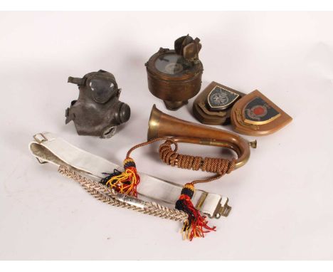 A collection of militaria, to include a brass and copper bugle, a gas mask and a brass compass