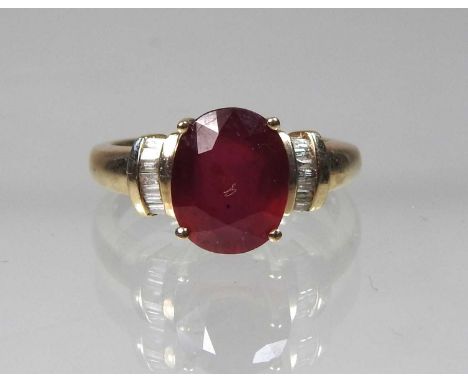 A 9ct gold ruby and diamond ring, the central cushion cut stone flanked by diamond set shoulders, approximately 2.5 carats, s