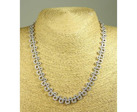 An 18 carat white gold and diamond set necklace, of graduated interlaced circle design, approximately 5.0 carats gross33 gram