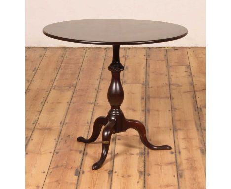A George III mahogany pedestal tripod table, having a one-piece circular tilt top to a baluster turned, spiral fluted and kno