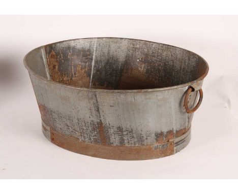 A galvanised metal oval planter, having twin ring handles, w.63cm