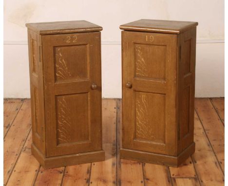 A pair of 'grained' or scumble pine bedside cupboards, each constructed from antique panelled church pews, numbered 19 and 22