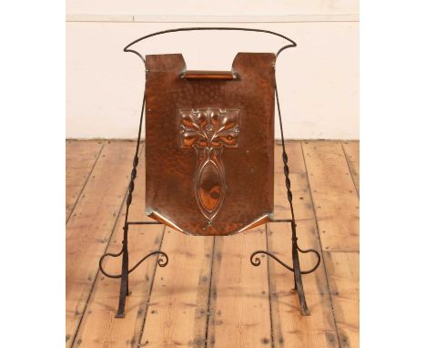 An Art Nouveau hammer-beaten copper and wrought iron fire screen, early 20th century, the applied copper panel with stylised 
