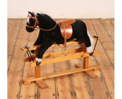 A child's rocking horse, mounted upon a pine base, l.93cm