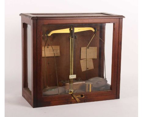 A mahogany cased set of weighing scales, 20th century, w.57cm