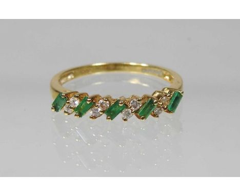 An 18 carat gold baguette cut emerald and diamond half hoop eternity ring, size P