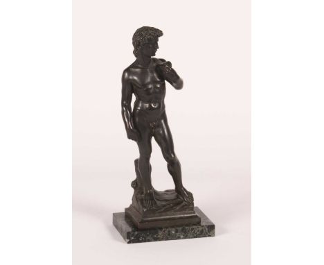 After Michelangelo, a bronze figure of David, mounted to a polished hardstone plinth, h.35cm