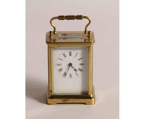 A brass carriage clock, the enamelled dial showing Roman numerals, having visible platform escapement, h.12cm