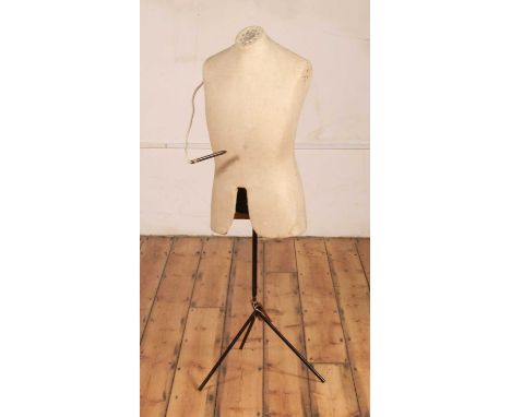 An early 20th century shop display mannequin, fabric clad and raised on enamelled metal rodded triform base, height 133cm