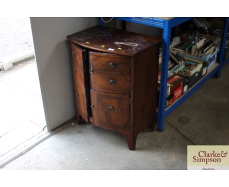 A mahogany bow front cupboard