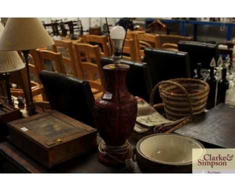 An Oriental red lacquered table lamp lacking shade 