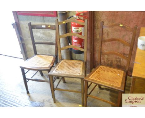 Three cane seated ladder back chairs