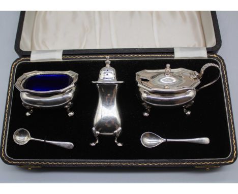 Three piece Sterling Silver Condiment Set To include an Open Salt with Salt Spoon, a Pepper Shaker and a Mustard Pot with Mus