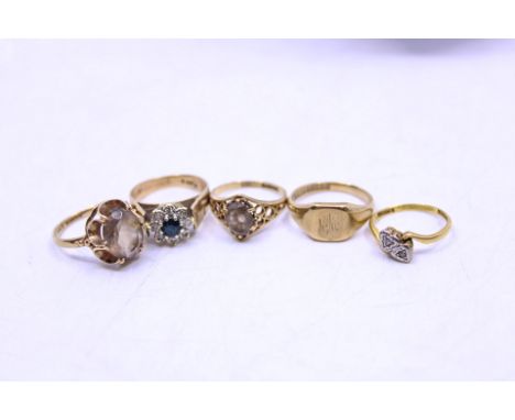Four 9ct Gold Rings and an 18ct Gold melee Two-Stone Diamond Ring  The 9ct Gold Rings include; an Oval Brilliant Cut Smoky Qu