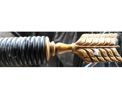 A Regency style large ebonized and fluted curtain pole and rings, formed as an arrow, gilt highlights,315cm long