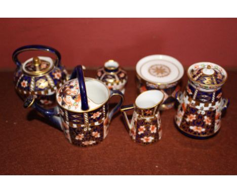 A group of Royal Crown Derby Imari miniatures comprising watering can, kettle, milk churn, drum, jug and vase, printed marks&