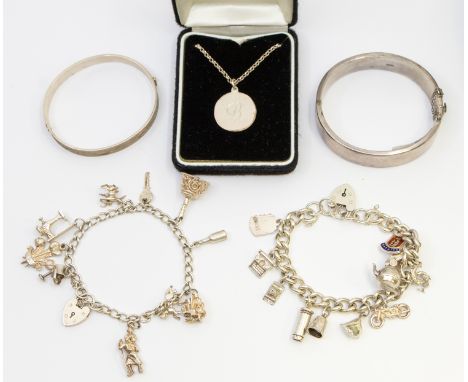 A selection of Sterling Silver Jewellery. To include two Vintage Silver Hinged Bangles, two Silver Charm Bracelets and a Unma