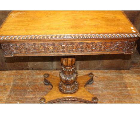 Heavily carved oak folding card table on central carved pedestal leg, table/playing surface has had new baize installed.  Goo