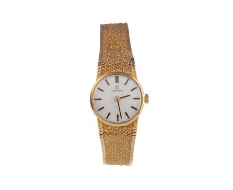 LADY'S OMEGA NINE CARAT GOLD MANUAL WIND WRIST WATCH,the round white dial with applied baton hour markers, 19mm case, on an a