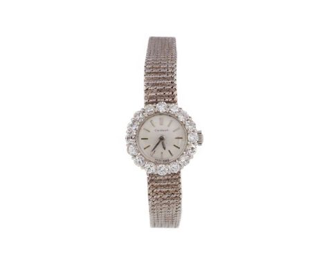 LADY'S CORTEBERT NINE CARAT GOLD DIAMOND SET MANUAL WIND WRIST WATCH,the round white dial with applied baton hour markers, ro