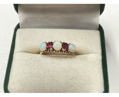 A 15ct ruby and Opal set ring, 2.9g. Size N. Postage category a