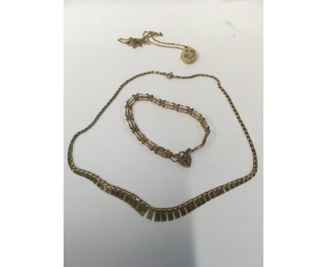 Two 9ct gold necklaces with a brooch pendant and an a gate bracelet. Approx weight 12.61 grams.