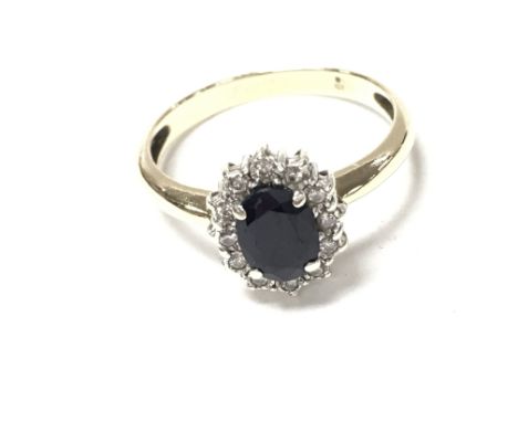 9ct yellow gold oval sapphire and RC diamond ring. Size O and 2.60g. Boxed.