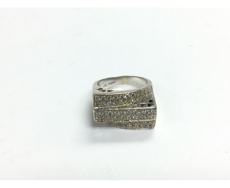 A 14k white gold ring set with three rows of diamond chips, approx 7.8g and approx size N. Shipping category A.