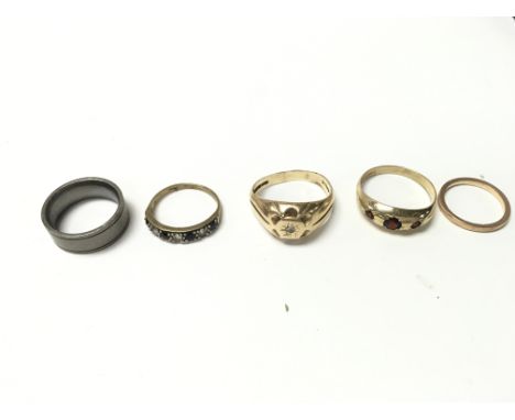 Collection of four 9ct gold rings 11.60g and one titanium ring.