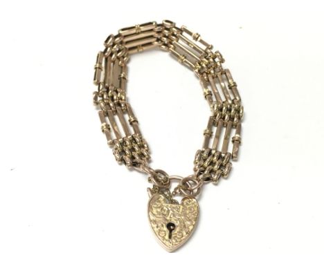 A 9ct gold gate bracelet with hand engraved padlock. 15.2g Postage A