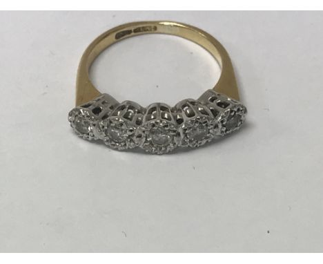 A 18 ct gold ring inset with a row of five diamonds.