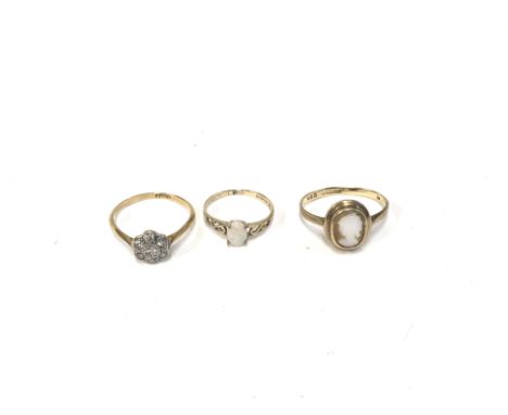 Three rings one set with chip diamonds, another set with a small opal and a small cameo ring. Approx weight 4.61 grams.