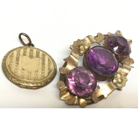 A yellow metal brooch set with amethyst and locket , postage category A