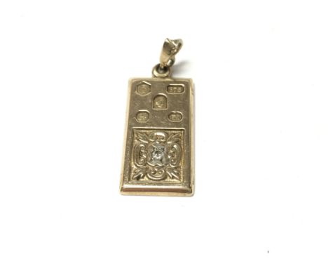 A 9ct diamond set ingot. 8g Postage A