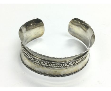 A silver bangle. Shipping category A.