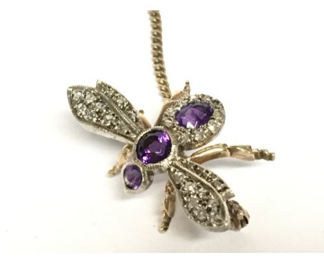 A 9ct gold bee pendant set with small diamond shards and amethyst stones. Overall weight 4.4g Postage category A