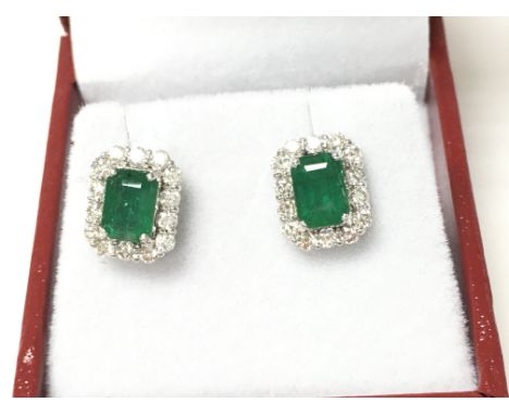 A pair of 18ct white gold emerald cut emerald and diamond cluster studs. Boxed. Emeralds 1.82ct diamonds 0.75ct. Postage B