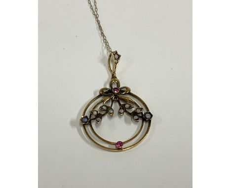 An Edwardian 9ct gold ruby and opal pendant. (A)