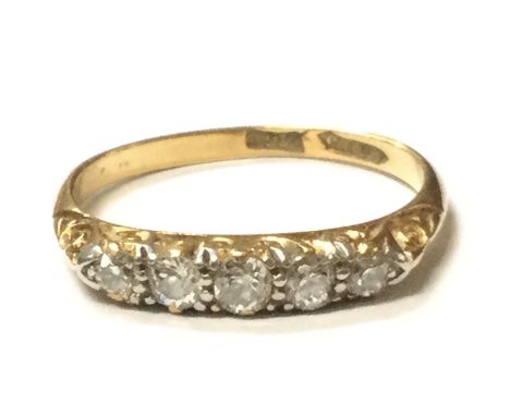 An 18ct gold five stone diamond ring , size O/P. Overall weight 2.6g. Postage category A