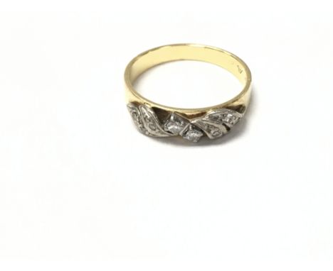 An 18ct yellow and white gold ring. Size n 1/2 and 3.54g.