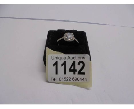 A silver ring set white stone, size R.