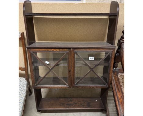 A dark oak wall cabinet / book shelf with astragal glazed doors