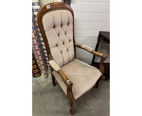 A mahogany armchair with deep button upholstery