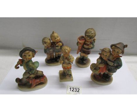 Five assorted Hummel child figures.