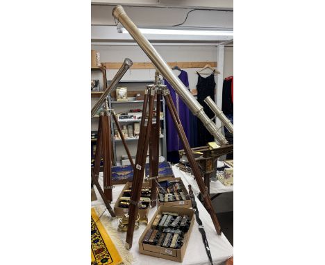 A large silver plated telescope on teak tripod