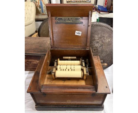A 19th century Seraphone paper roller organ retailed by Peter Black, Manchester.43 x 30 x Height 29cm Has 1 roll. Roll has 3 