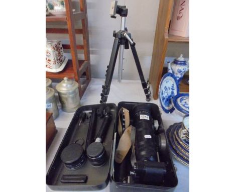 A Zenit 12S camera with lenses, tripod and hard case.Wind on lever operates as does shutter button. 