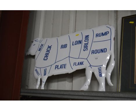 An enamel cow sign 